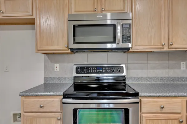a kitchen with a stove and a microwave