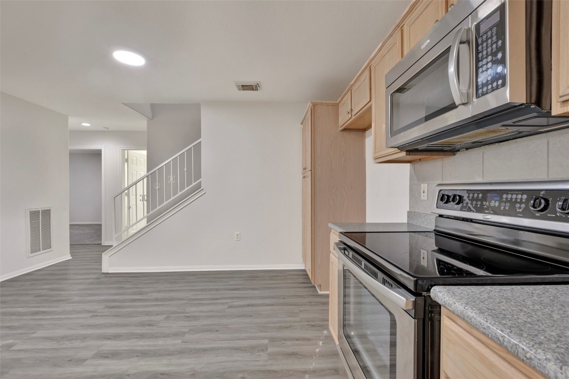770 Hunt Road, Unit 212 Baytown, TX 77521 - Photo 24 of 40 a kitchen with a stove and a microwave