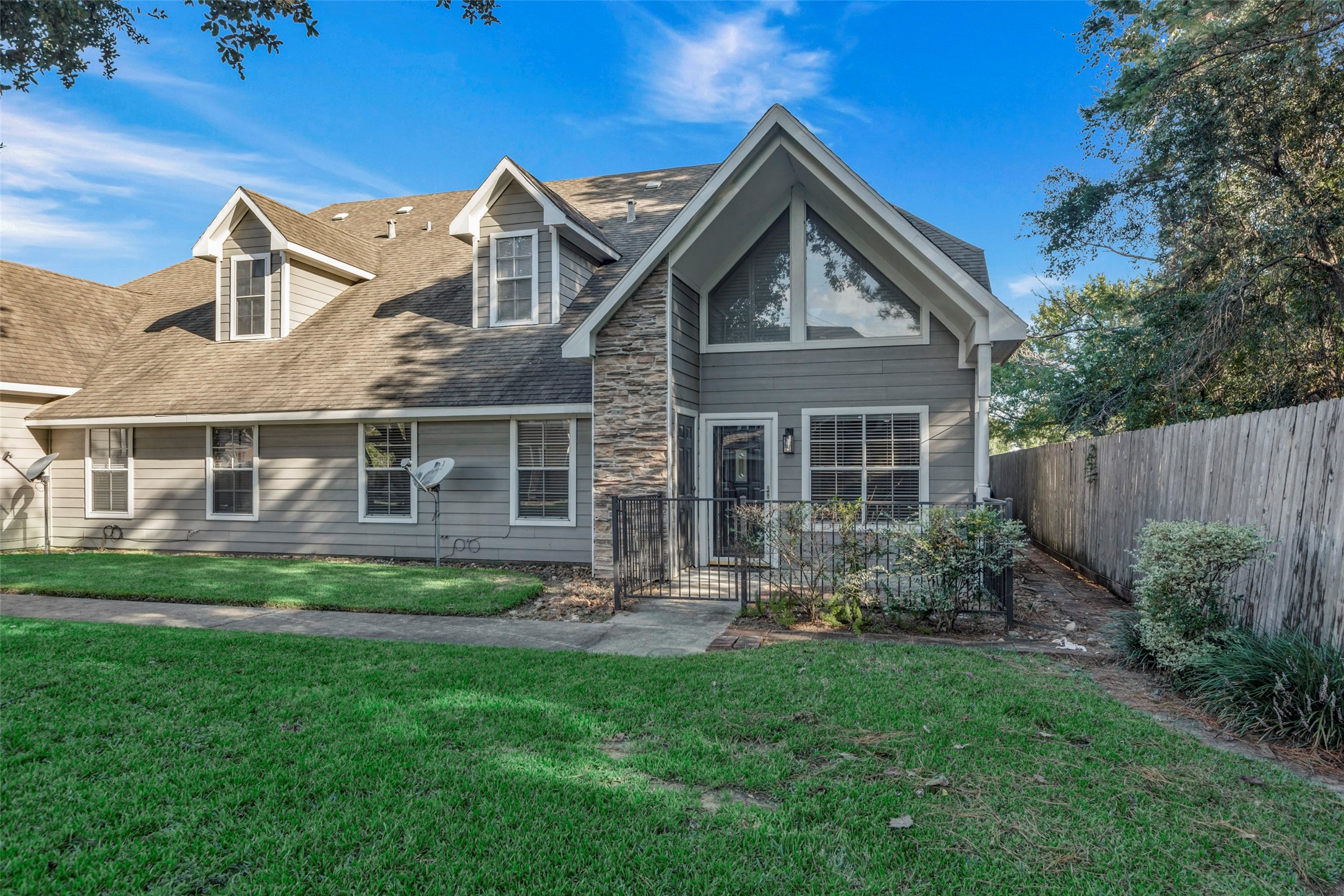 770 Hunt Road, Unit 212 Baytown, TX 77521 - Photo 3 of 40 a front view of a house with a yard and outdoor seating