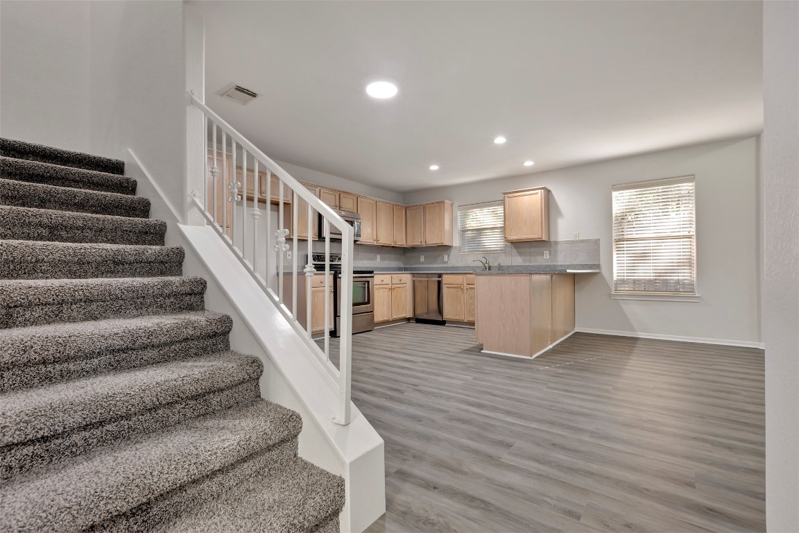 770 Hunt Road, Unit 212 Baytown, TX 77521 - Photo 31 of 40 a view of a kitchen with wooden floor and electronic appliances