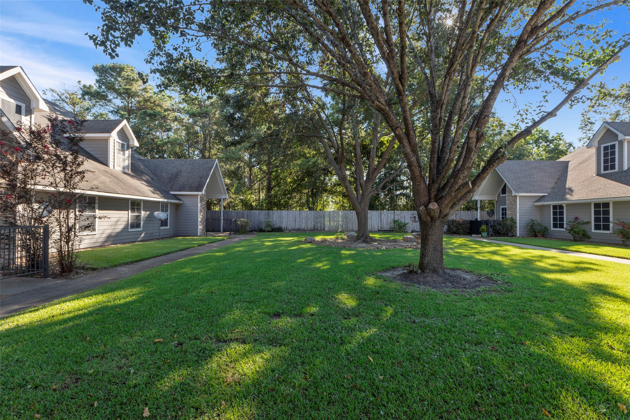 770 Hunt Road, Unit 212 Baytown, TX 77521 - Photo 39 of 40 a view of a house with a yard deck and a large tree