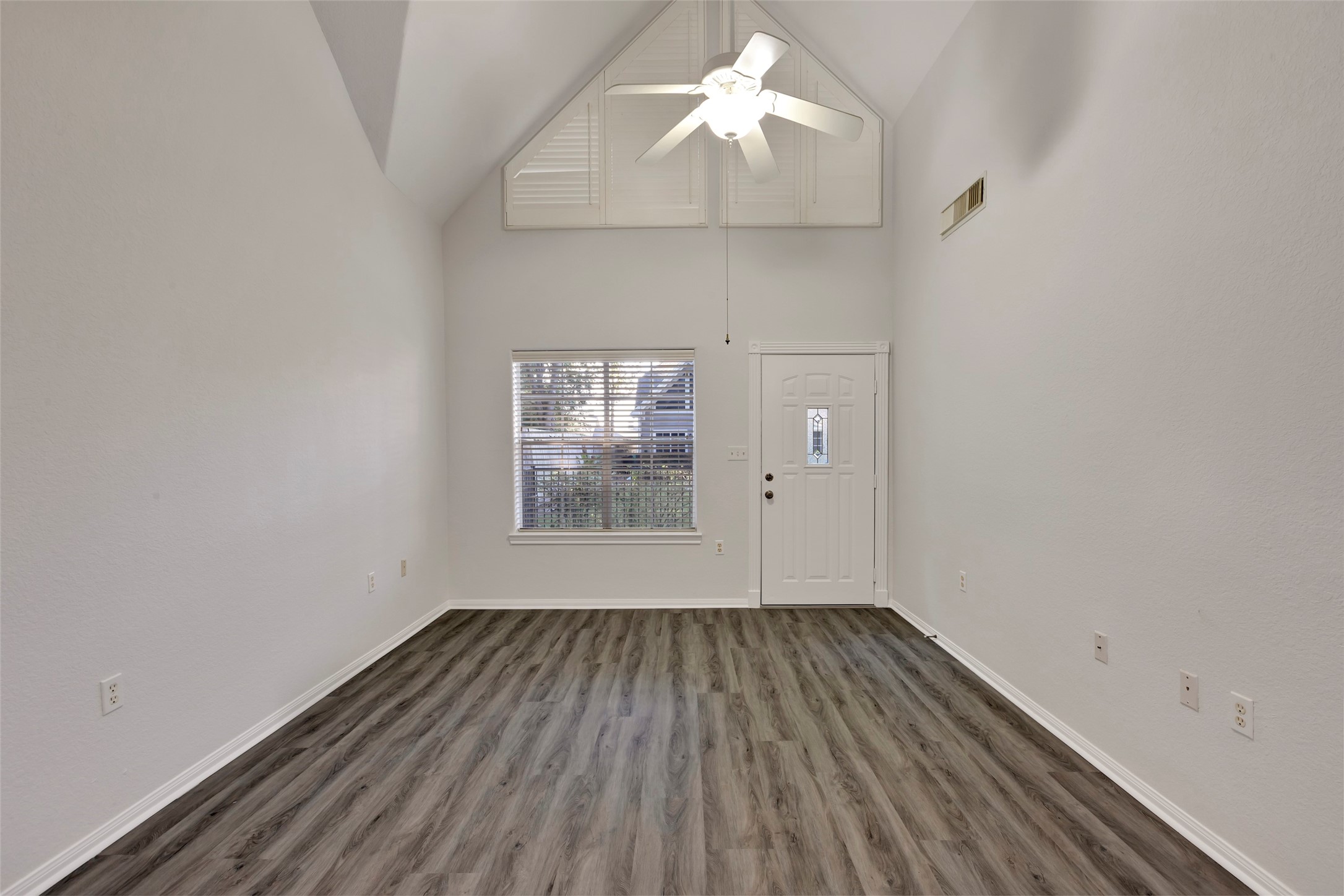 770 Hunt Road, Unit 212 Baytown, TX 77521 - Photo 9 of 40 a view of a room with wooden floor a chandelier fan and windows