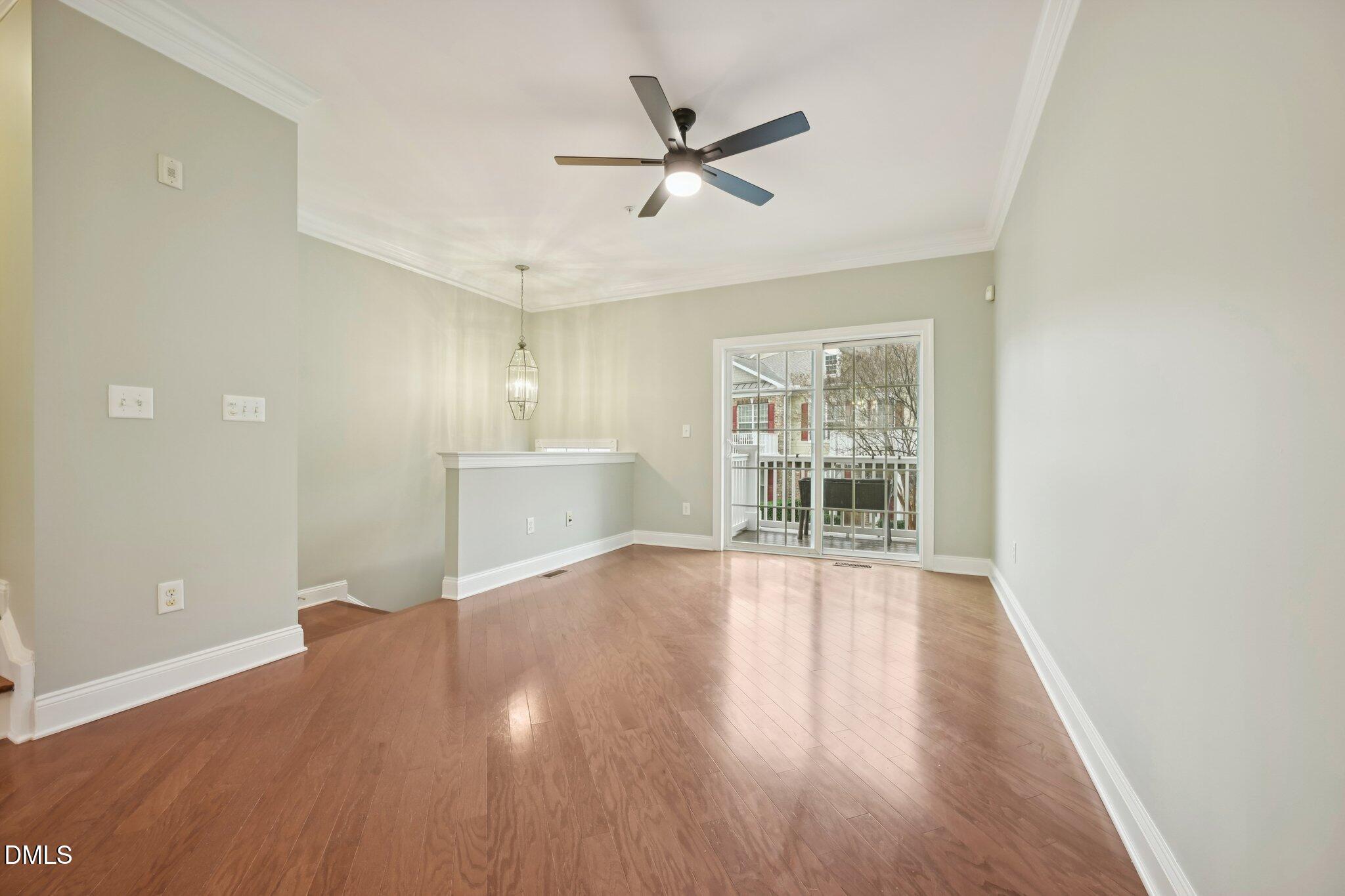 10510 Sablewood Drive, Unit 113 Raleigh, NC 27617 - Photo 6 of 38 a view of an empty room with a window and wooden floor