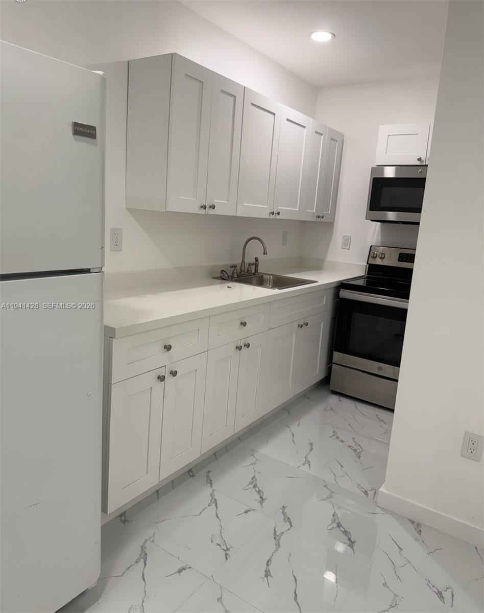 4200 Southwest 96th Avenue, Unit 2 Miami, FL 33165 - Photo 3 of 10 a kitchen with white cabinets and white appliances