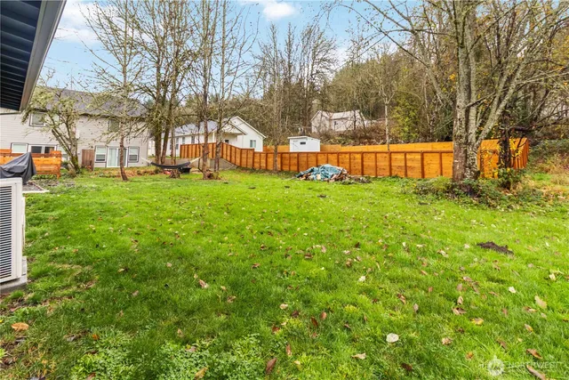 a view of yard with swimming pool and trees