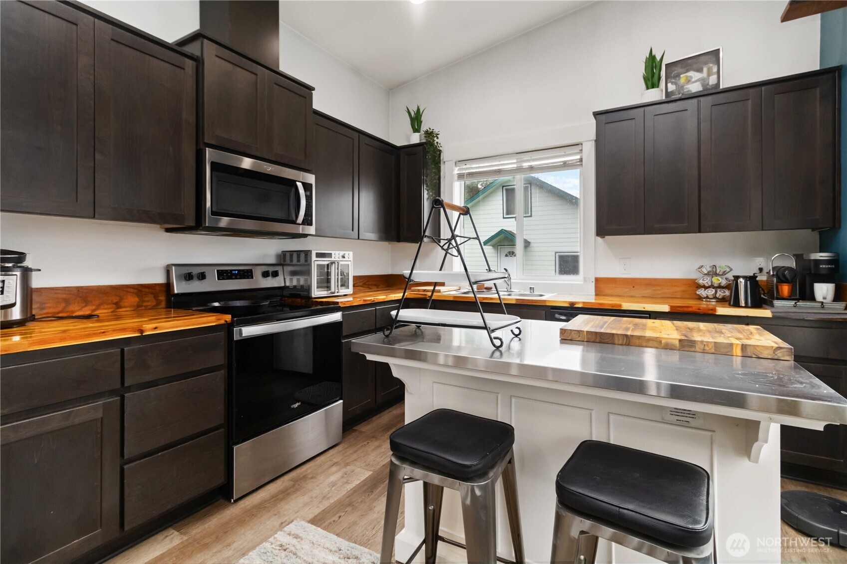 810 Southeast 1st Street Winlock, WA 98596 - Photo 27 of 35 a kitchen with kitchen island granite countertop a sink counter top space cabinets and stainless steel appliances