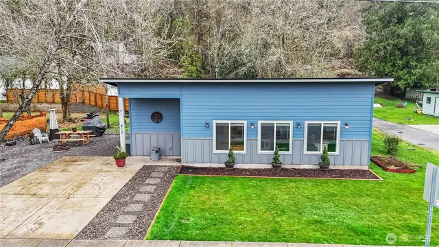 a backyard of a house with table and chairs