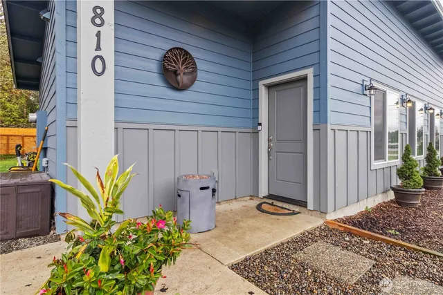 a view of a door and chair in back of the house