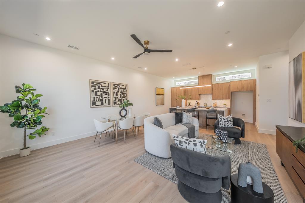5320 Reiger Avenue, Unit 102 Dallas, TX 75214 - Photo 2 of 33 a living room with furniture and a potted plant