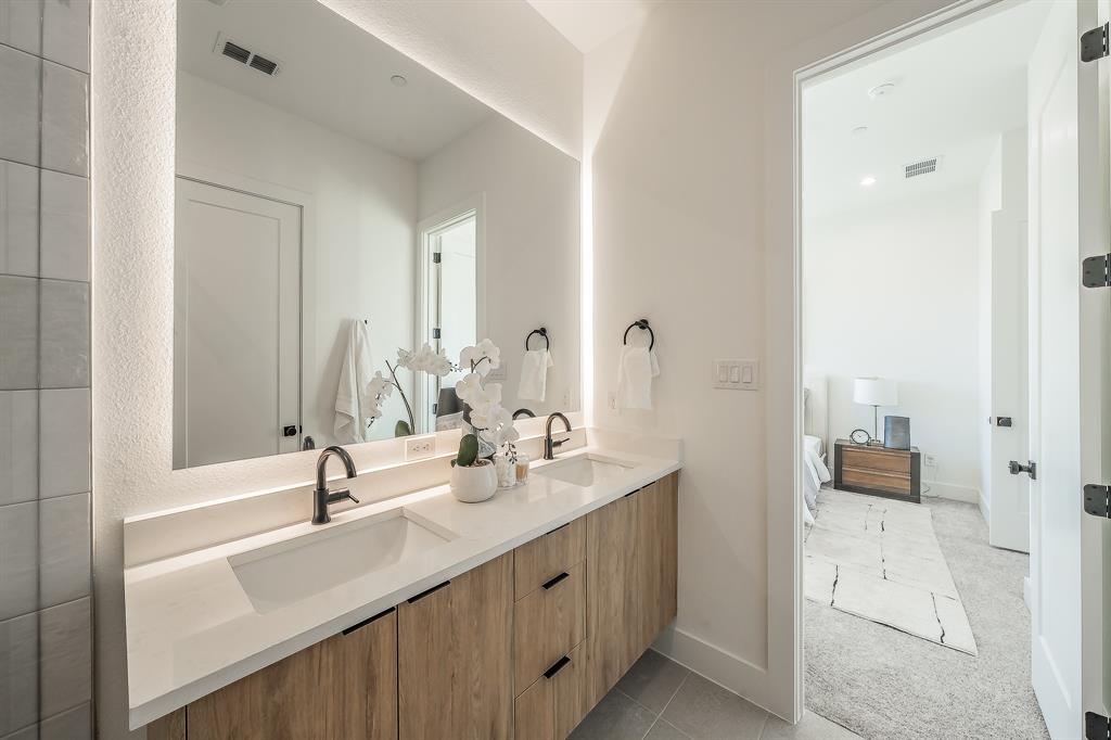 5320 Reiger Avenue, Unit 102 Dallas, TX 75214 - Photo 21 of 33 a bathroom with a double vanity sink mirror and shower