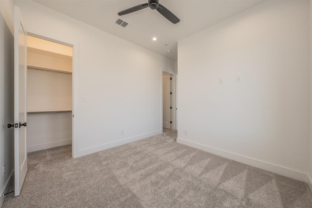 5320 Reiger Avenue, Unit 102 Dallas, TX 75214 - Photo 24 of 33 an empty room with a ceiling fan and carpet