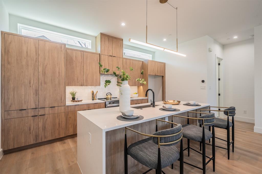 5320 Reiger Avenue, Unit 102 Dallas, TX 75214 - Photo 8 of 33 a kitchen with a table chairs stove and microwave