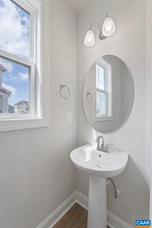 a kitchen with kitchen island a sink stainless steel appliances and wooden floor