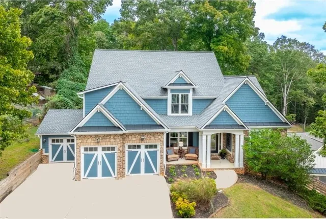 a aerial view of a house with a yard patio and outdoor seating