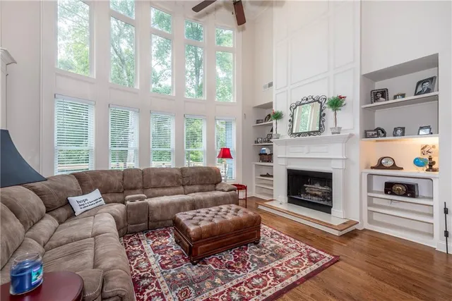 a living room with furniture fireplace and flat screen tv