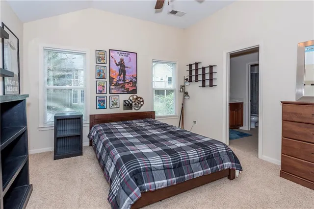 a bedroom with bed and a chandelier