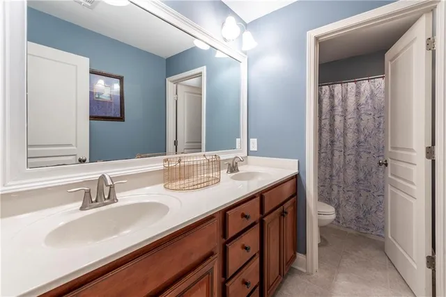 a bedroom with a bed a dresser and a window