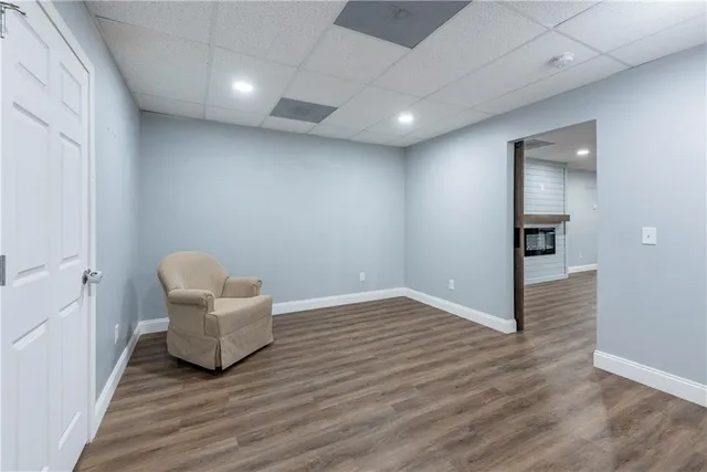 a kitchen with a refrigerator a sink dishwasher and a stove with wooden floor
