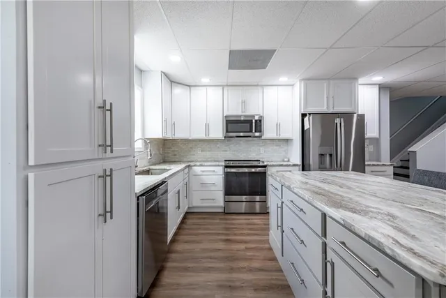 a front view of a house with a yard and trees