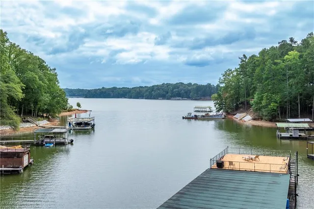 a view of a patio with couches table and chairs and potted plants