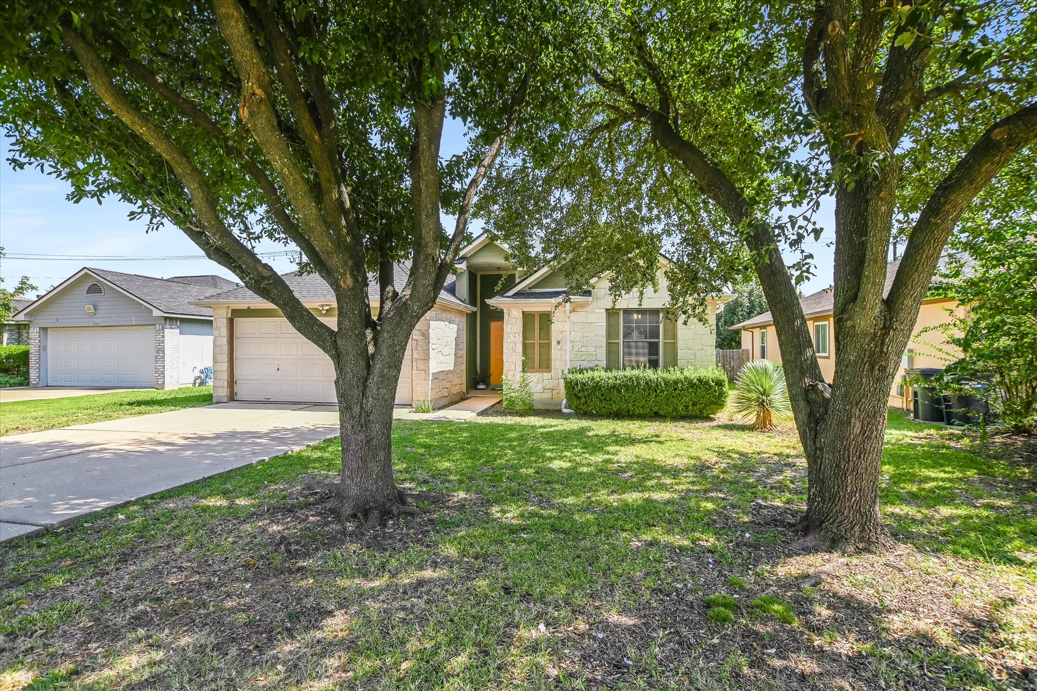1302 Redbud Lane Leander, TX 78641 - Photo 24 of 28 a view of a house with backyard and a tree
