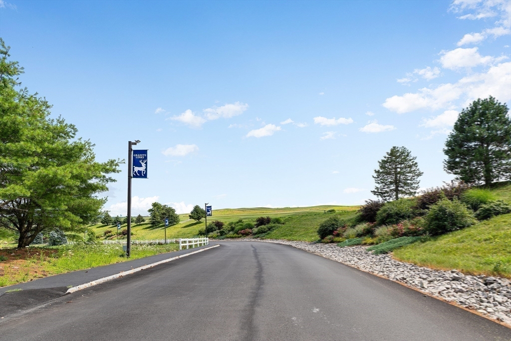 2 Ricciuti Drive, Unit 9 Quincy, MA 02169 - Photo 35 of 40 a view of a road with a big yard