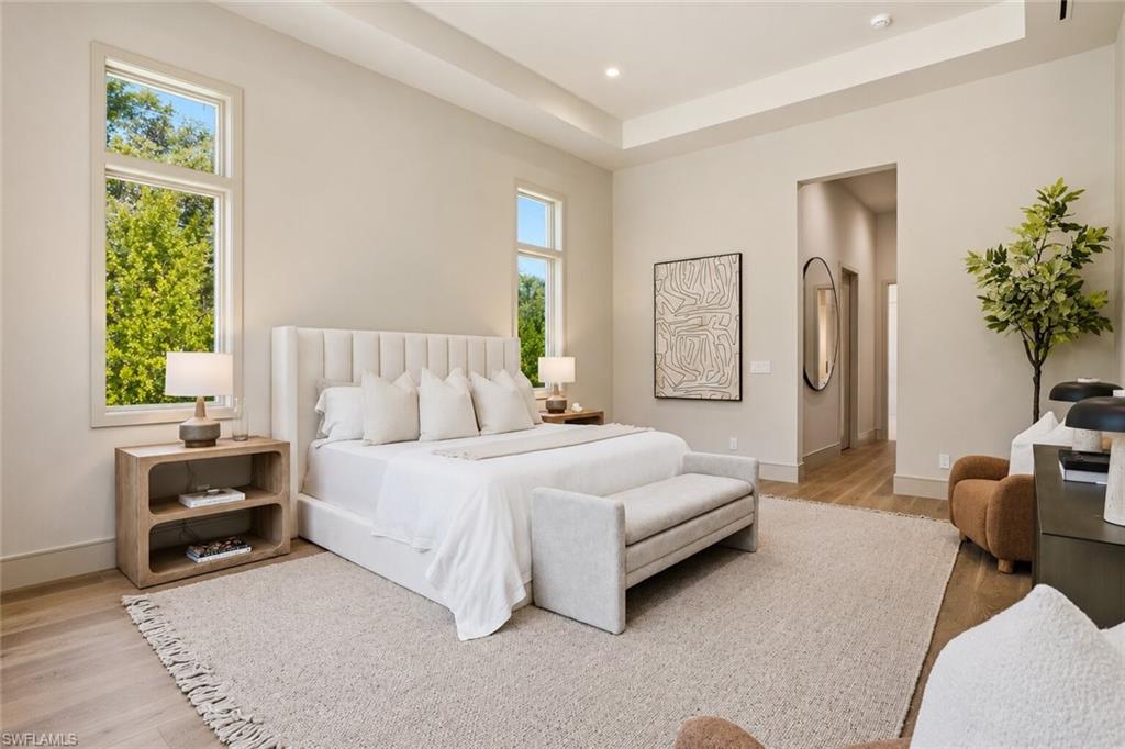 4851 Crayton Road Naples, FL 34103 - Photo 15 of 33 a bedroom with a bed and a couch
