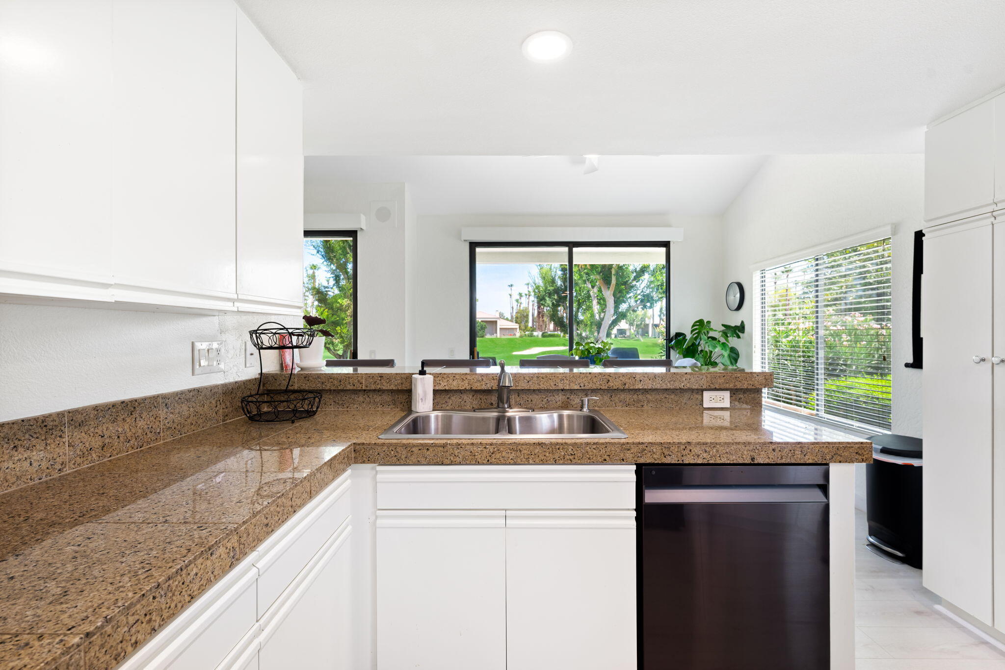 54912 Shoal Creek La Quinta, CA 92253 - Photo 13 of 36 a kitchen with granite countertop a large window and a sink