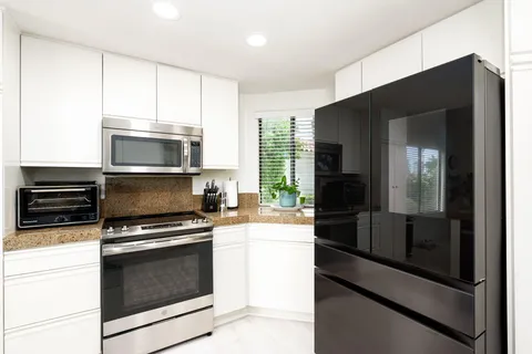 a kitchen with a refrigerator stove and microwave