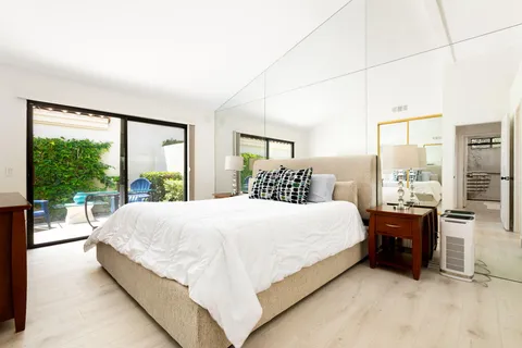 a large bed sitting in a bedroom next to a large window