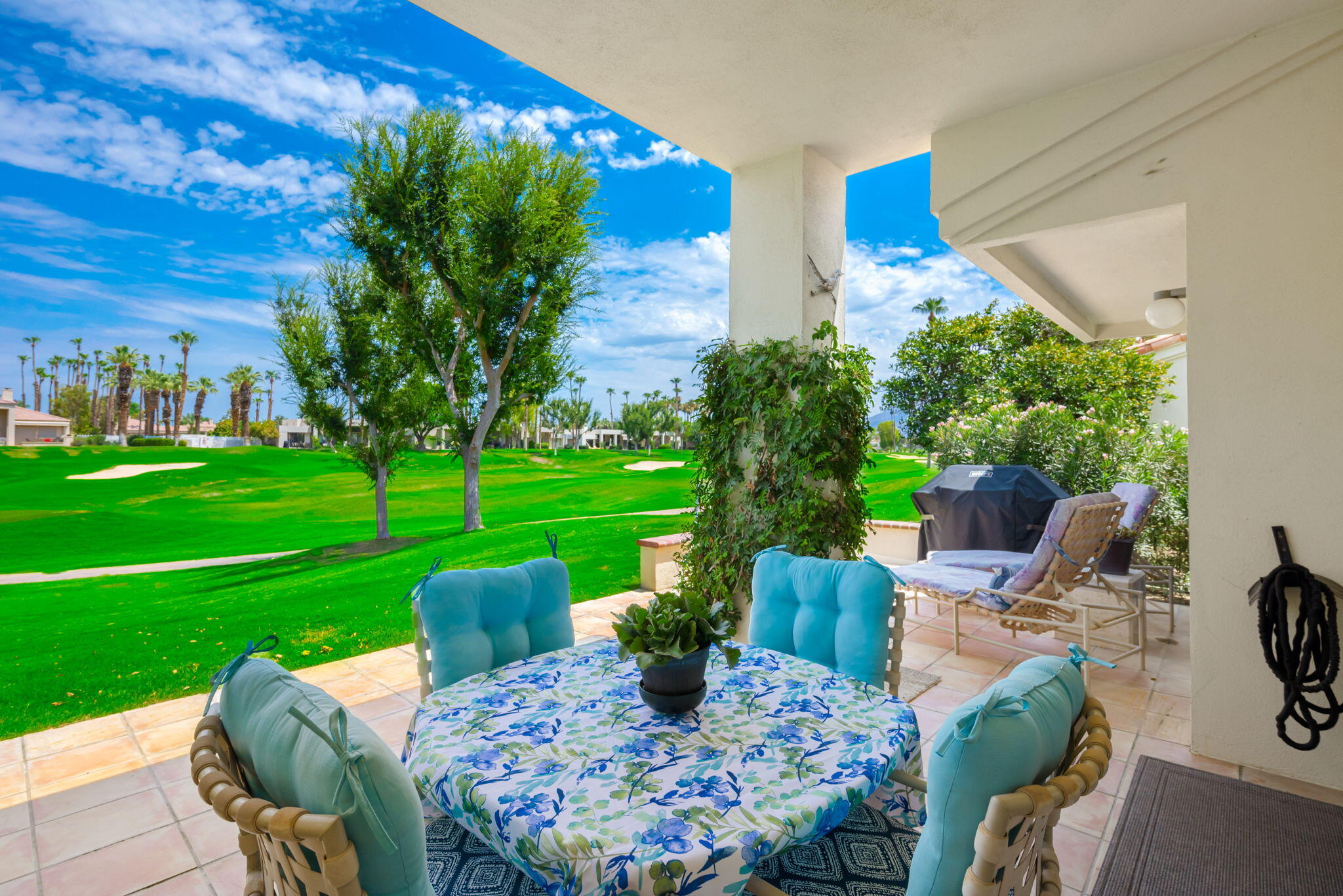 54912 Shoal Creek La Quinta, CA 92253 - Photo 30 of 36 a view of a patio with table and chairs potted plants and a large tree