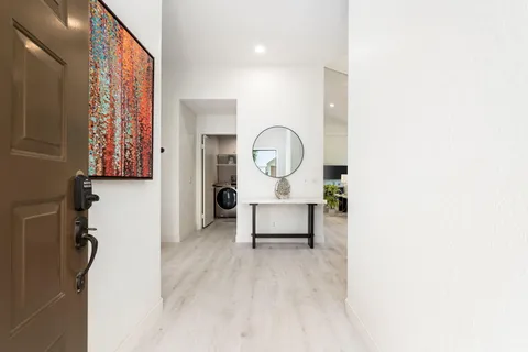 a living room with furniture and a wall painting