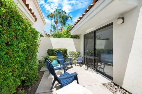 a view of a patio with table and chairs and potted plants