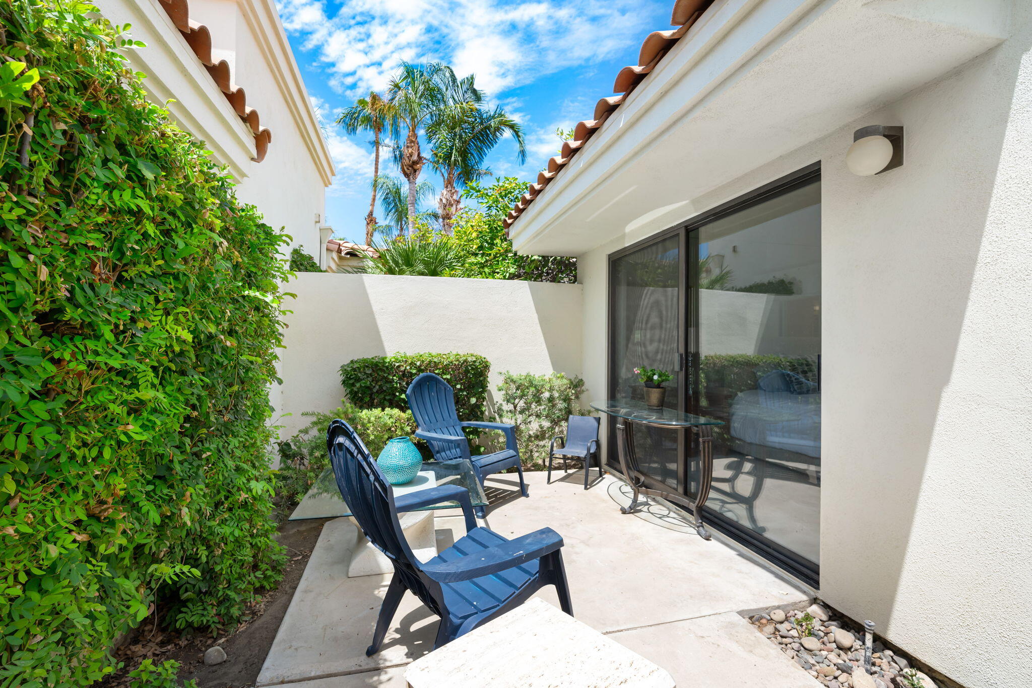 54912 Shoal Creek La Quinta, CA 92253 - Photo 35 of 36 a view of a patio with table and chairs and potted plants