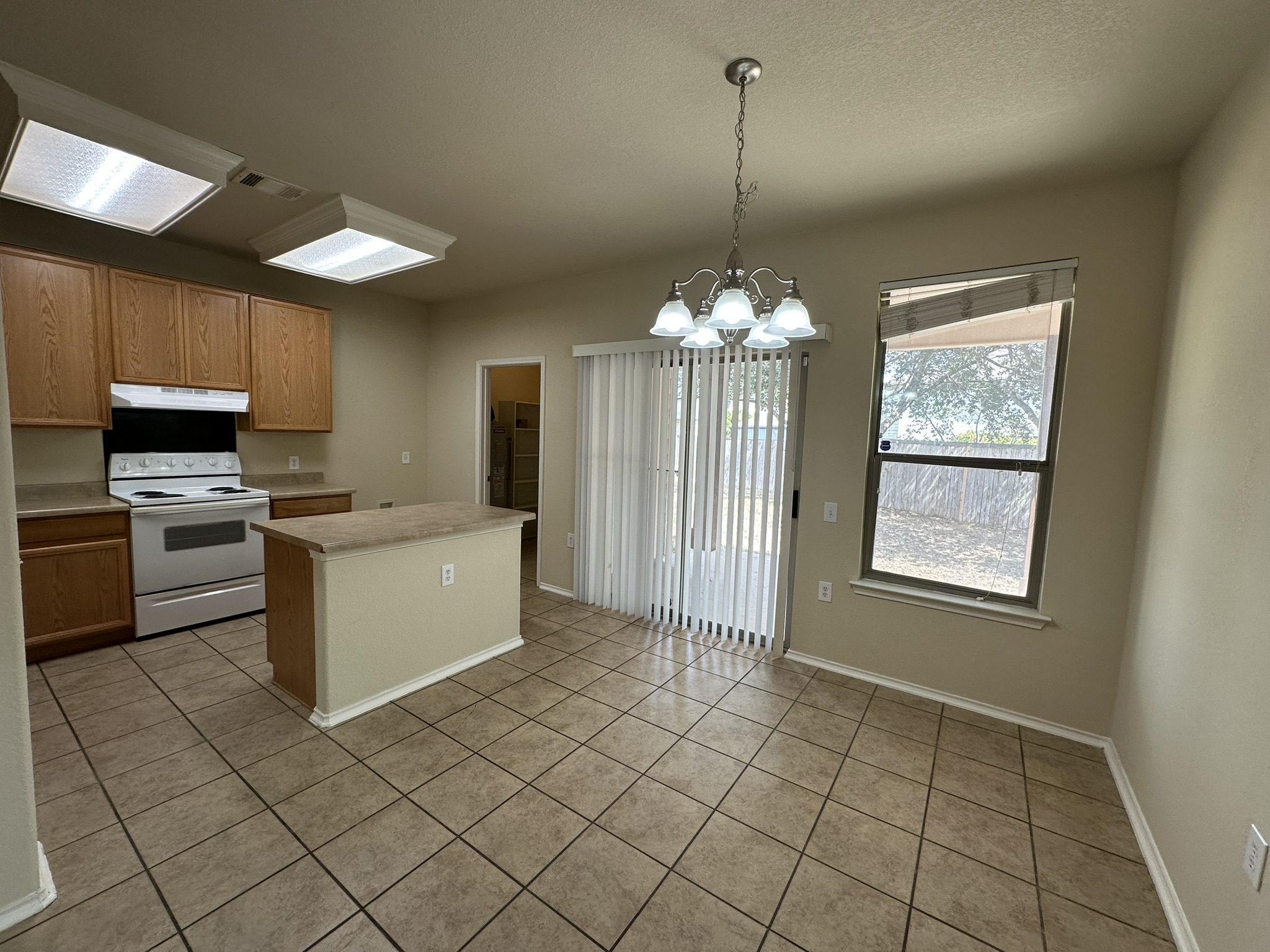 4507 Peach Grove Road Austin, TX 78744 - Photo 8 of 35 Durable tile flooring spans this casual dining area adjoining the kitchen space.