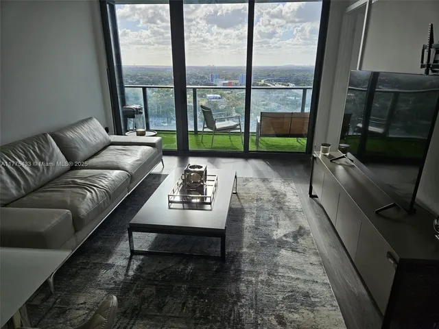 a kitchen with granite countertop a refrigerator and a stove top oven