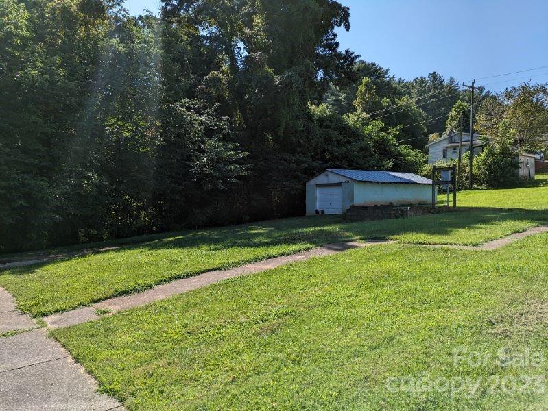 100 West 4th Street Marion, NC 28752 - Photo 6 of 10 a view of a backyard with a small cabin
