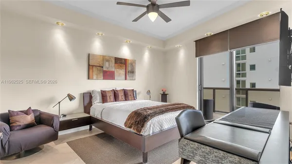 a bedroom with furniture and a view