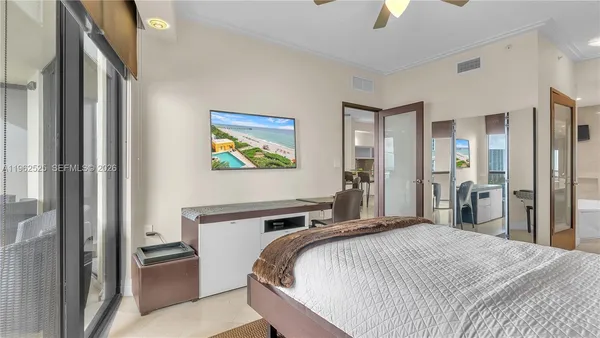 a bedroom with a bed and a chandelier