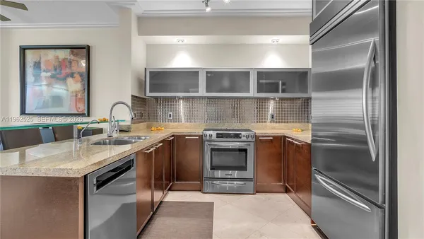 a kitchen with stainless steel appliances granite countertop a sink stove and refrigerator