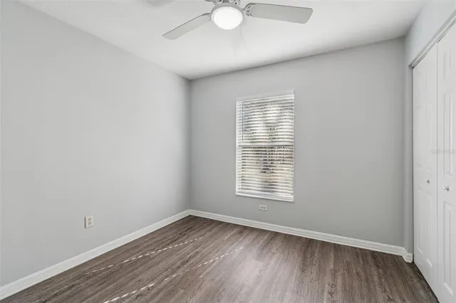 a view of a room with wooden floor and cabinet