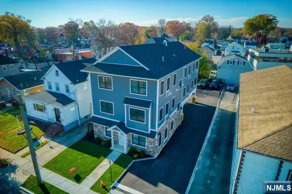an aerial view of a house with a yard