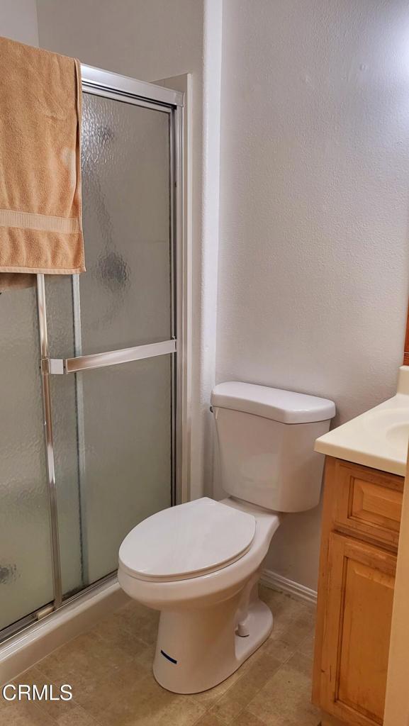 2065 East Bard Road Oxnard, CA 93033 - Photo 12 of 18 a white toilet sitting next to a shower