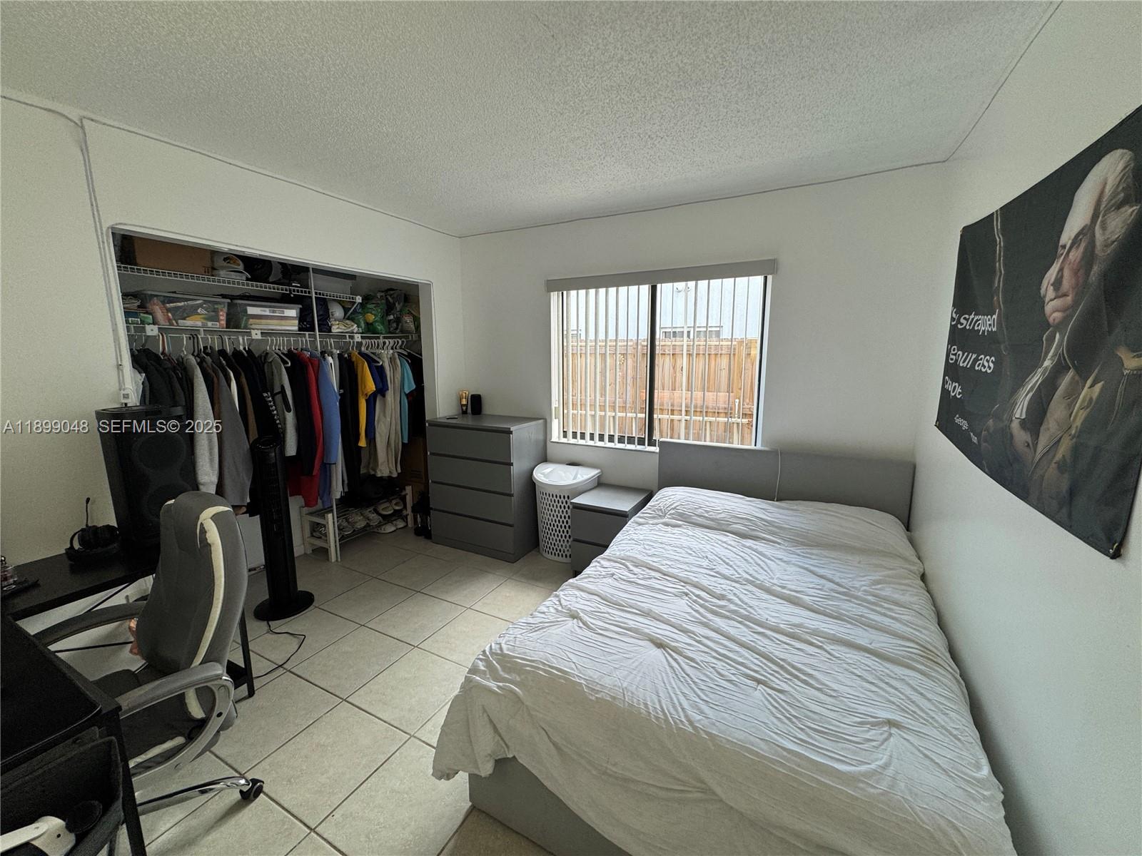 14700 Southwest 151st Terrace Miami, FL 33196 - Photo 11 of 19 a bedroom with a bed and a closet