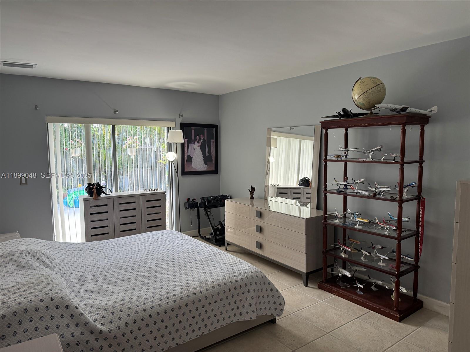 14700 Southwest 151st Terrace Miami, FL 33196 - Photo 13 of 19 a bedroom with a bed and wooden floor