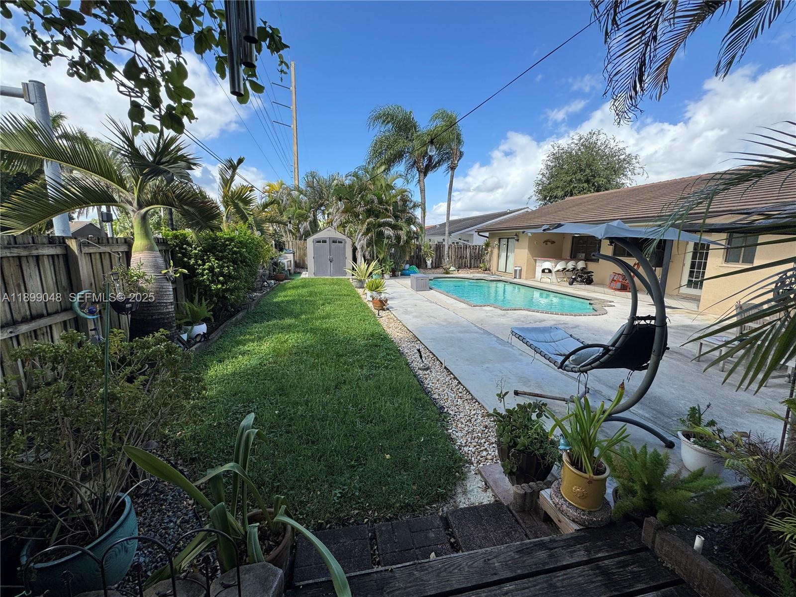 14700 Southwest 151st Terrace Miami, FL 33196 - Photo 17 of 19 a front view of a house with garden