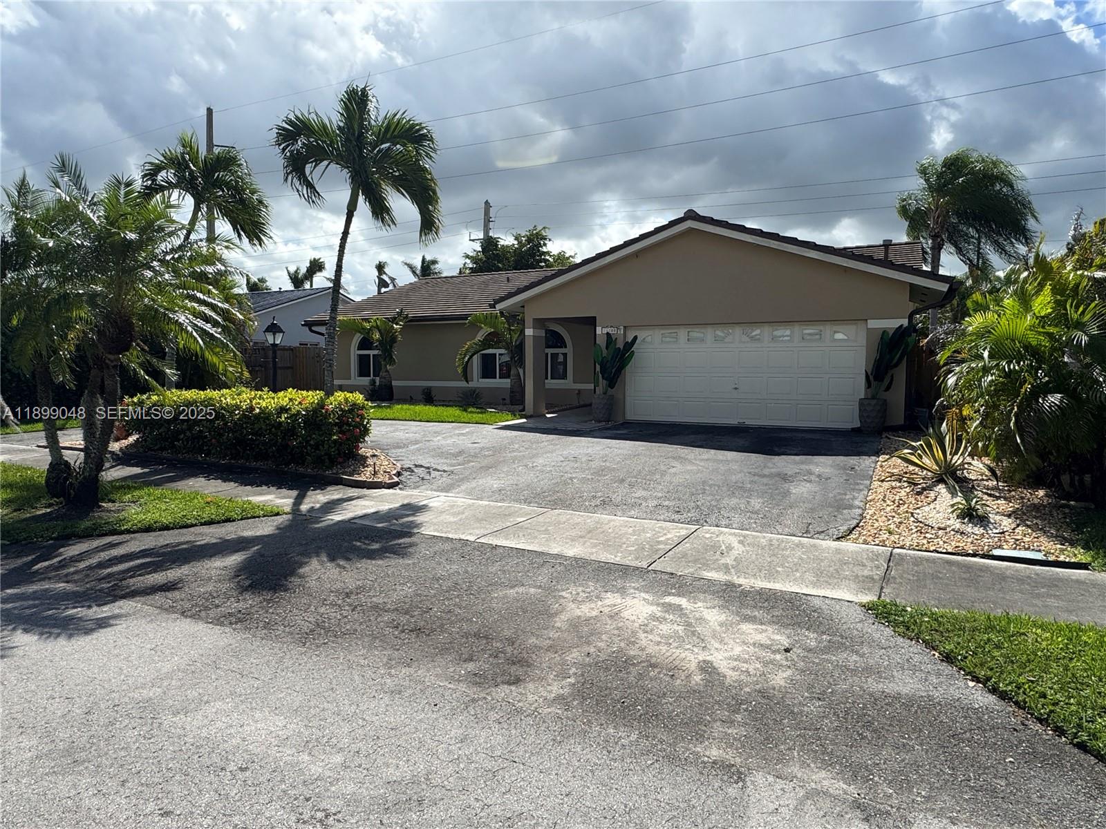 14700 Southwest 151st Terrace Miami, FL 33196 - Photo 19 of 19 a view of a house with a yard and potted plants