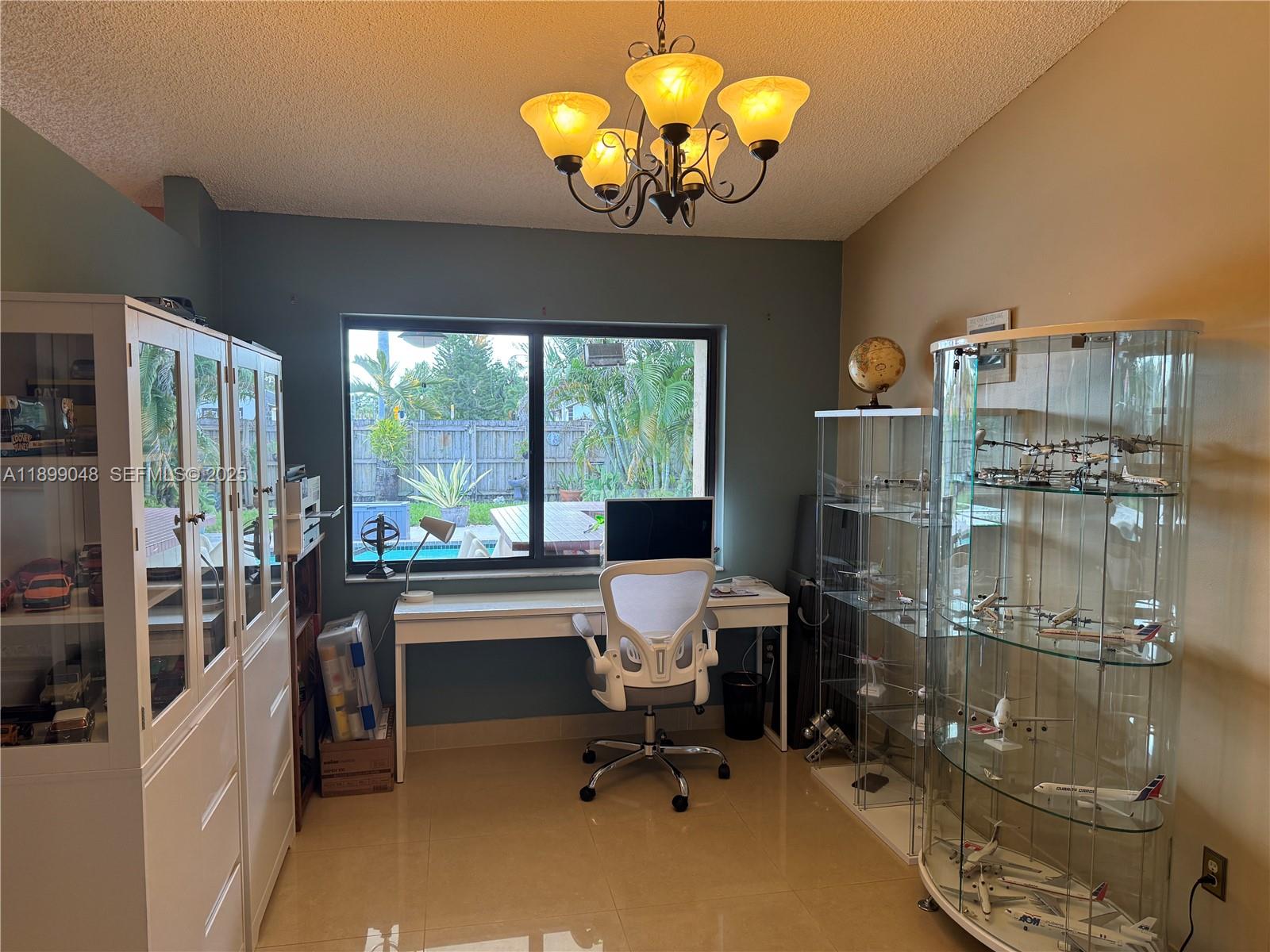 14700 Southwest 151st Terrace Miami, FL 33196 - Photo 4 of 19 a view of a dining room with furniture a chandelier and large windows