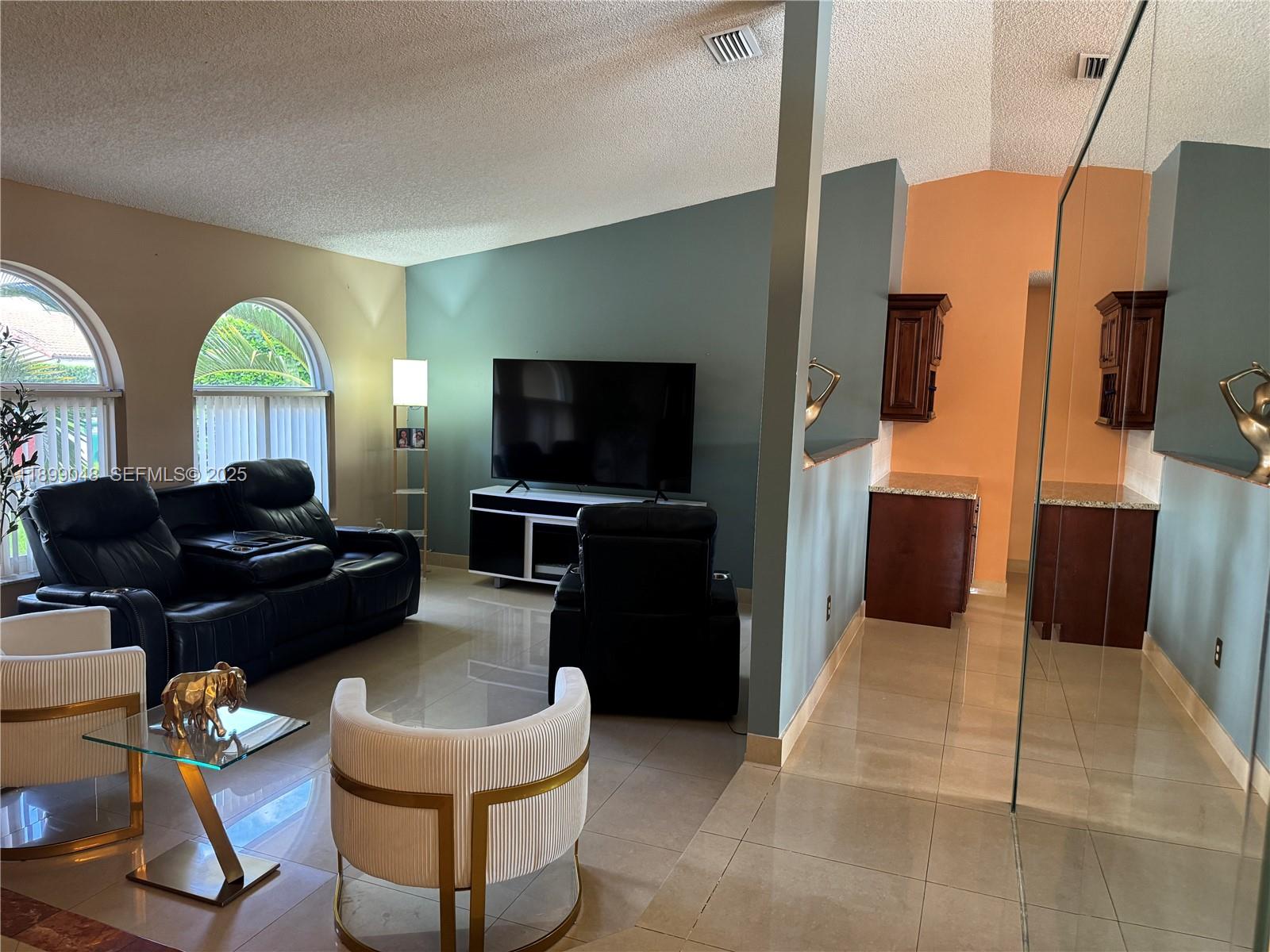 14700 Southwest 151st Terrace Miami, FL 33196 - Photo 7 of 19 a living room with furniture and a flat screen tv