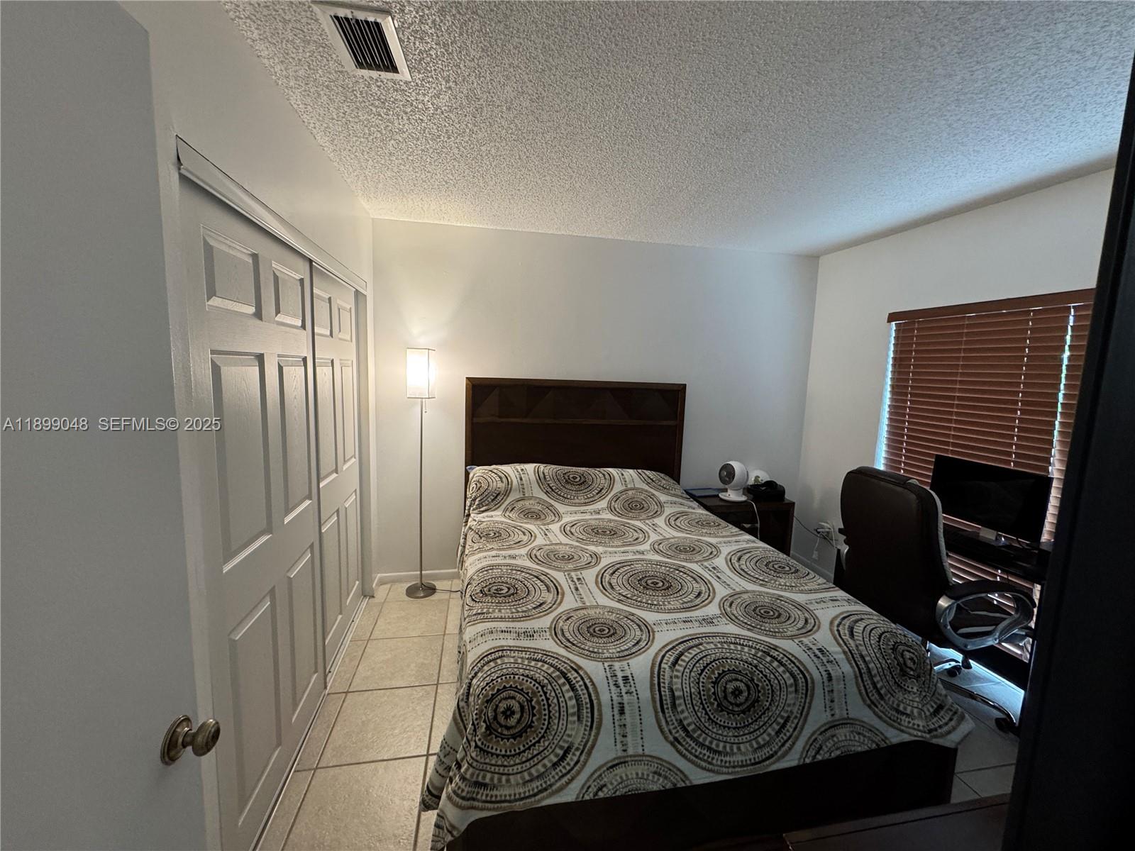 14700 Southwest 151st Terrace Miami, FL 33196 - Photo 10 of 19 a bedroom with a bed and a television
